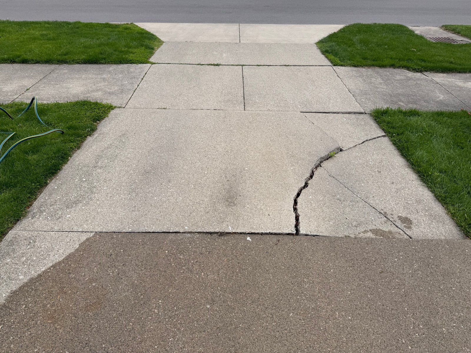 Existing damaged concrete driveway before replacement by Duncan Concrete LLC
